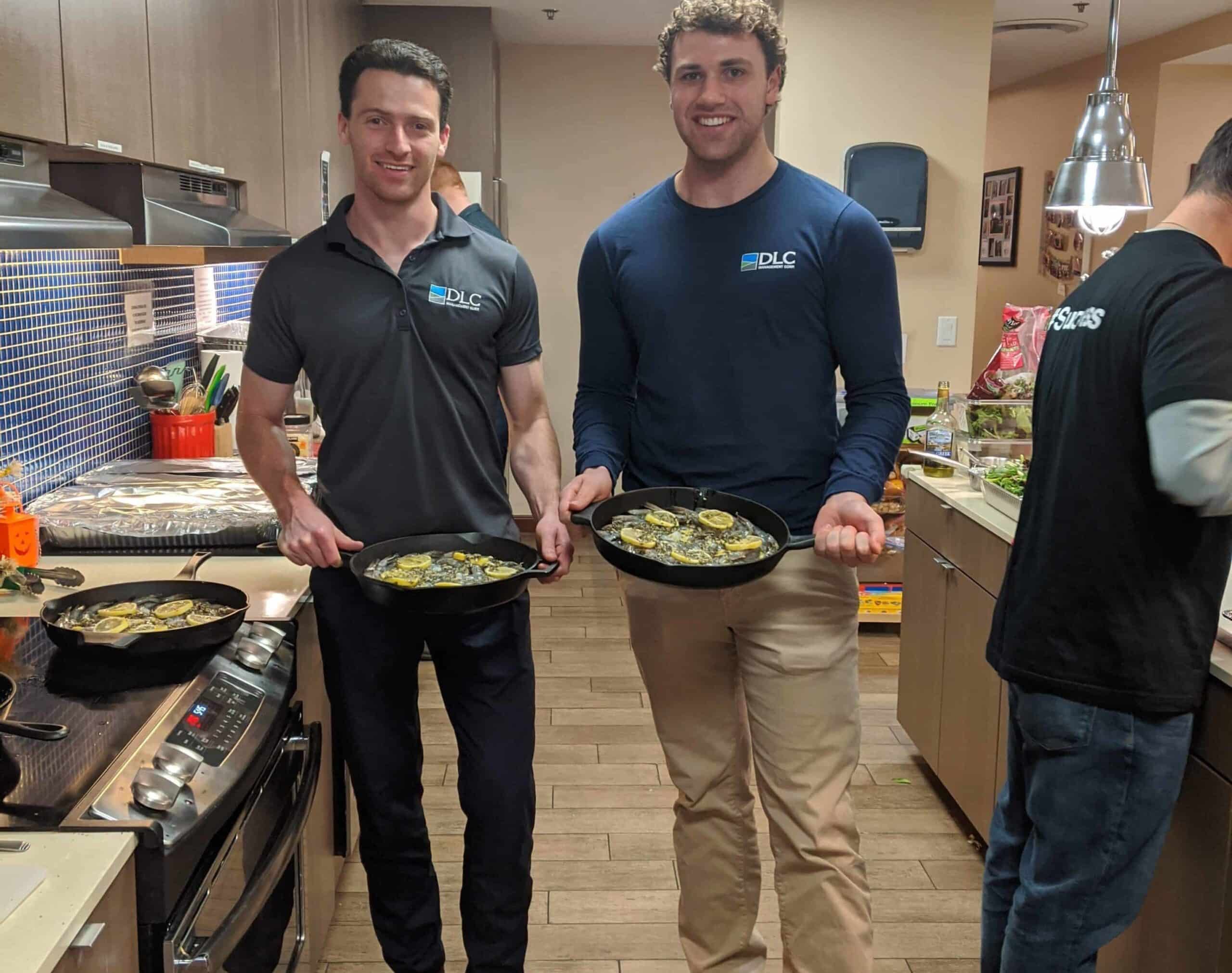 Colleagues holding pans of food at Ronald McDonald House