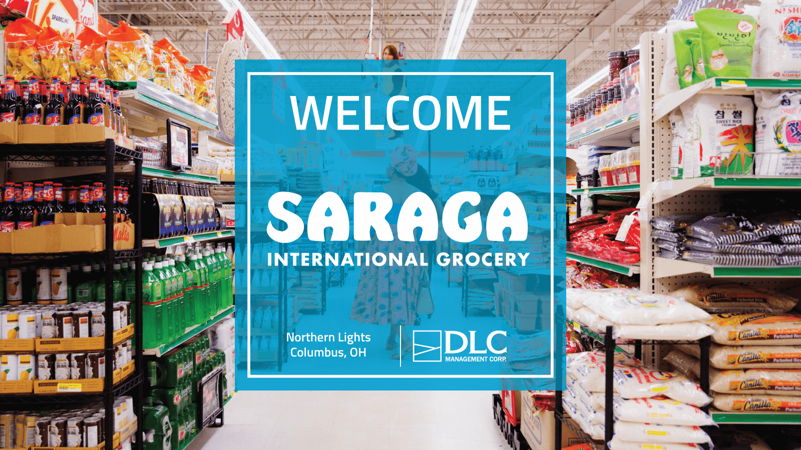 Grocery store aisle with a "Welcome Saraga International Grocery" graphic