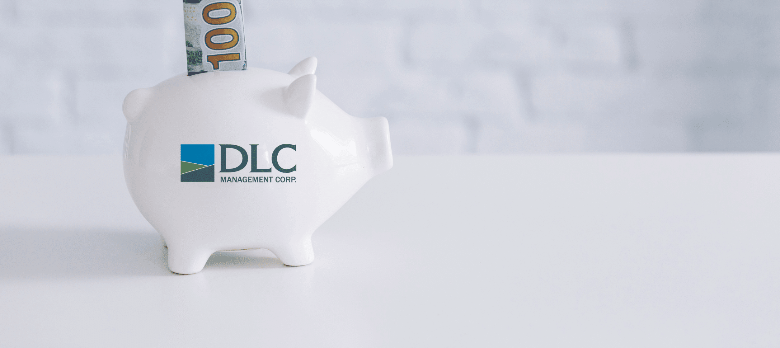 DLC piggy bank with a $100 bill sticking out