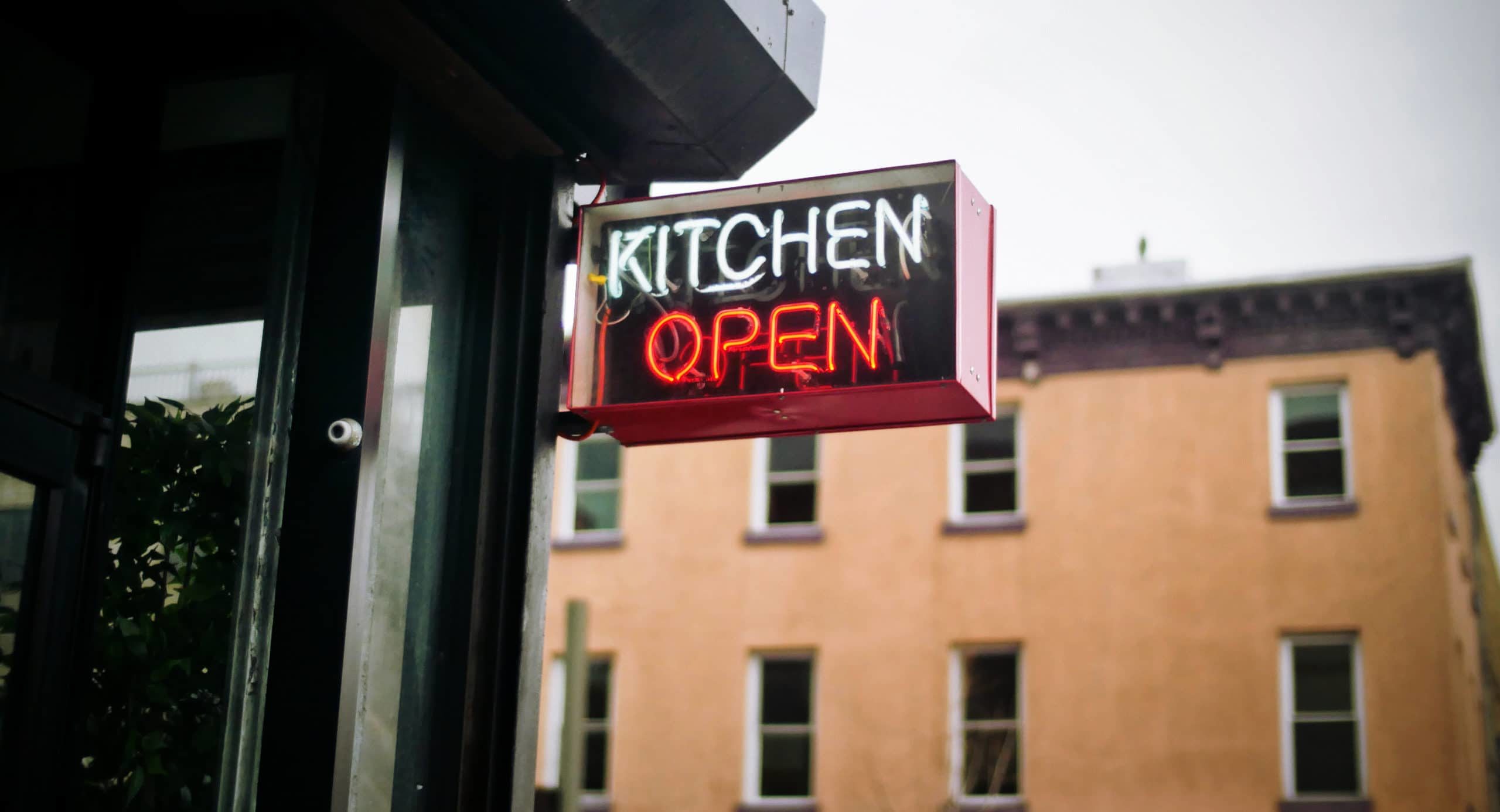 "Kitchen Open" sign on restaurant